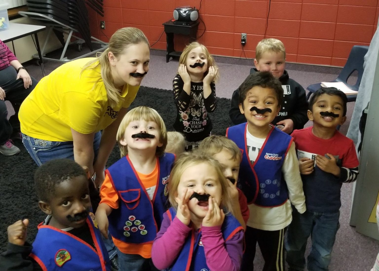 A cubbies group wearing funny mustaches.