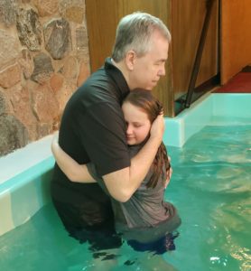 A child getting baptized.